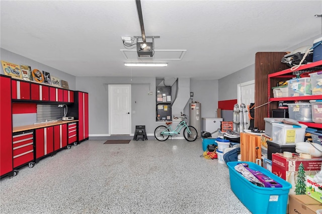 garage featuring a garage door opener, water heater, and baseboards