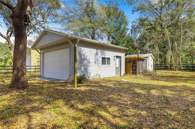 view of home's exterior featuring an outdoor structure and fence