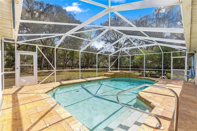 pool featuring glass enclosure and a patio