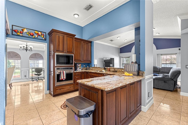 kitchen with oven, a peninsula, a sink, visible vents, and open floor plan