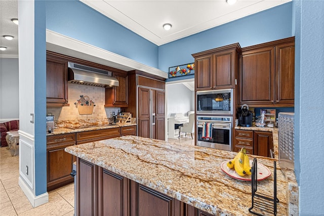 kitchen with light tile patterned floors, backsplash, black appliances, light stone countertops, and wall chimney exhaust hood