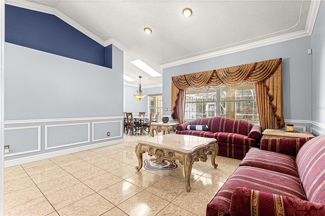 living room with a textured ceiling, a decorative wall, wainscoting, and crown molding