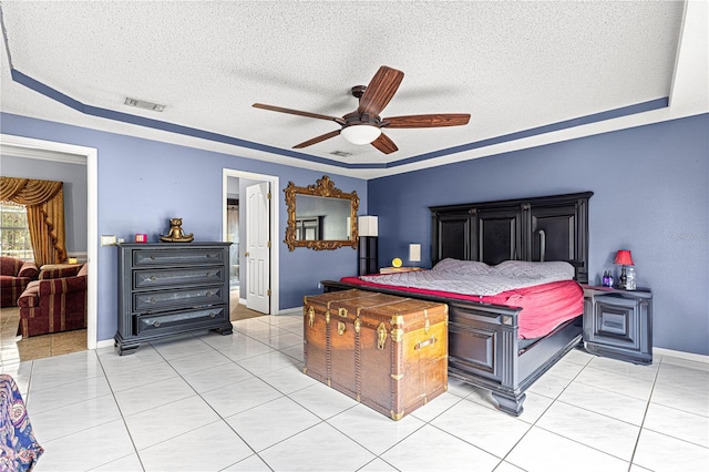 bedroom featuring a raised ceiling, visible vents, and light tile patterned floors