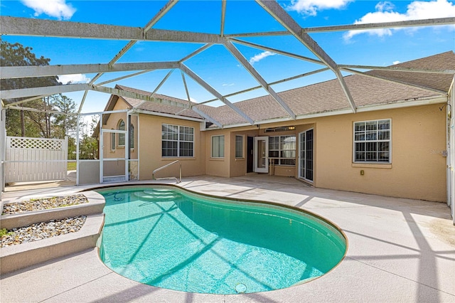 view of pool featuring glass enclosure, a patio area, and a fenced in pool