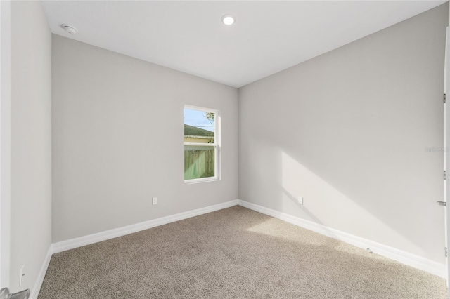 unfurnished room with carpet floors, recessed lighting, and baseboards