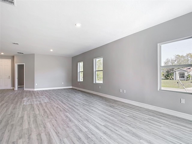 spare room featuring recessed lighting, visible vents, baseboards, and light wood finished floors