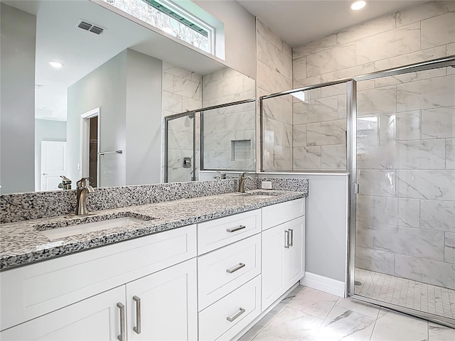full bathroom featuring a shower stall, visible vents, marble finish floor, and a sink