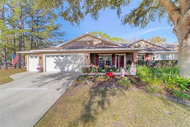 single story home with a garage, driveway, and stucco siding