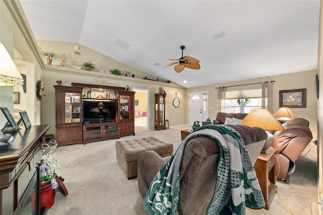 living room featuring carpet floors, ceiling fan, visible vents, and vaulted ceiling