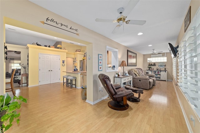 living area featuring a ceiling fan, recessed lighting, baseboards, and wood finished floors