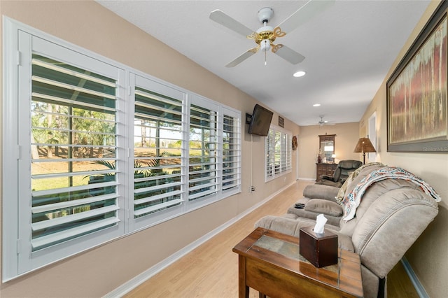 living area with light wood finished floors, ceiling fan, baseboards, and recessed lighting