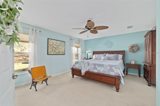 bedroom with light colored carpet, visible vents, baseboards, and multiple windows