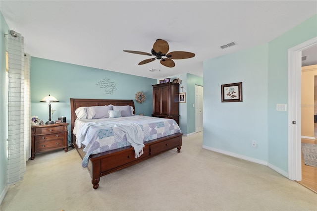 bedroom with baseboards, a ceiling fan, visible vents, and light colored carpet