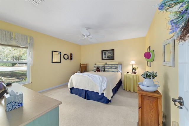 bedroom with baseboards, a ceiling fan, visible vents, and light colored carpet