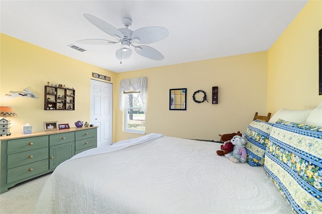 bedroom with a closet, visible vents, ceiling fan, and light carpet