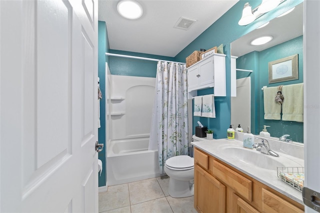 full bathroom with visible vents, toilet, shower / bath combo with shower curtain, vanity, and tile patterned flooring