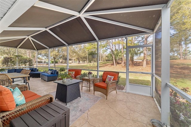 exterior space featuring glass enclosure and an outdoor hangout area