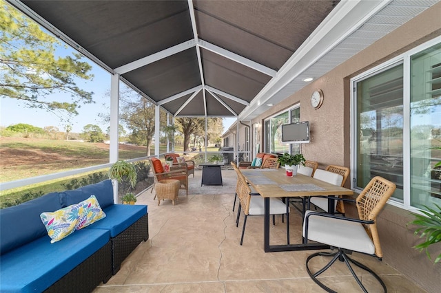 view of patio featuring outdoor dining area, an outdoor living space, and a lanai