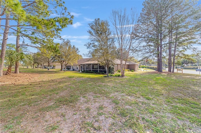 view of yard featuring a sunroom