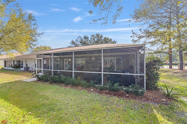 back of house featuring central AC and a lawn