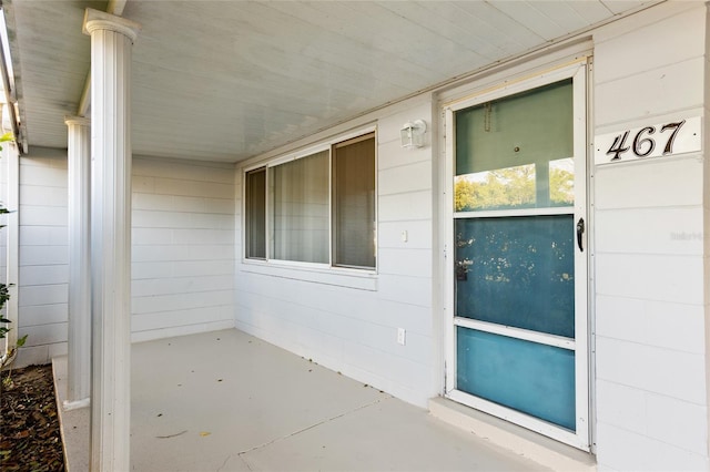 view of exterior entry featuring a porch