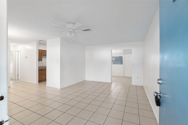 unfurnished room featuring visible vents, ceiling fan, baseboards, and light tile patterned floors