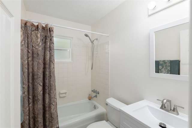 bathroom featuring a textured ceiling, shower / tub combo, vanity, and toilet