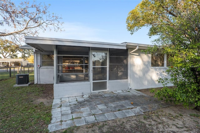 back of house with a patio area, a sunroom, central AC, and fence