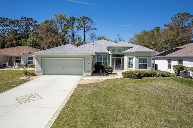 single story home with a garage, stucco siding, driveway, and a front yard