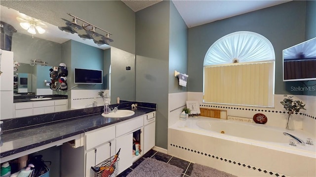 full bath featuring vanity, a bath, and tile patterned floors