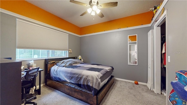 carpeted bedroom with a ceiling fan and baseboards