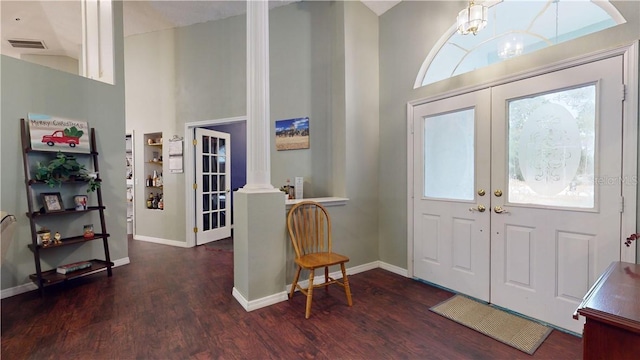 entryway featuring french doors, visible vents, wood finished floors, plenty of natural light, and ornate columns