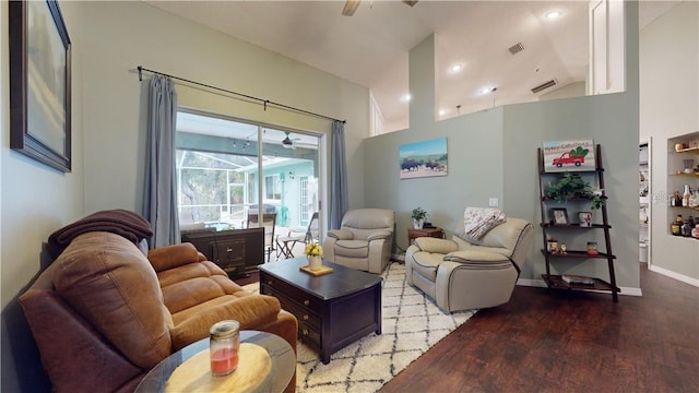 living area featuring baseboards, ceiling fan, visible vents, and wood finished floors