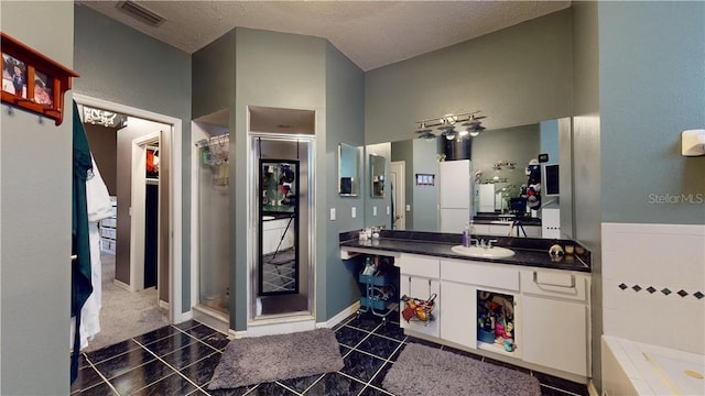 full bath featuring vanity, tile patterned flooring, a shower stall, and visible vents