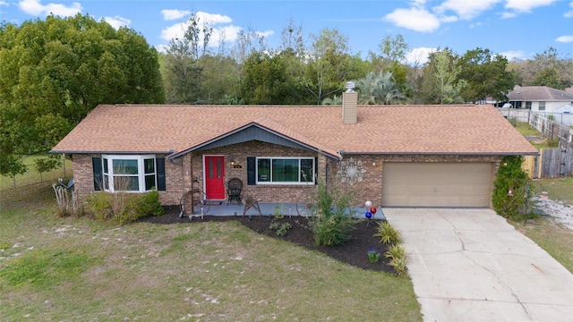 ranch-style home with concrete driveway, a chimney, an attached garage, fence, and a front lawn