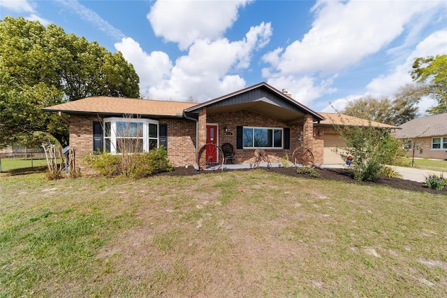 ranch-style home featuring a front lawn, brick siding, and an attached garage