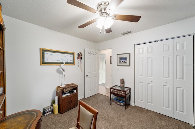 interior space with ceiling fan, visible vents, and a textured ceiling