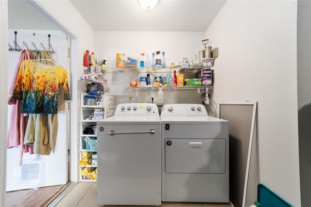 clothes washing area featuring laundry area and washing machine and clothes dryer