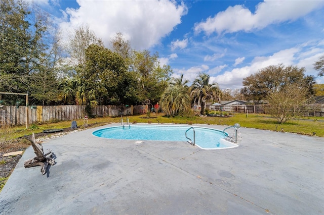 view of swimming pool featuring a patio, a yard, a fenced backyard, and a fenced in pool