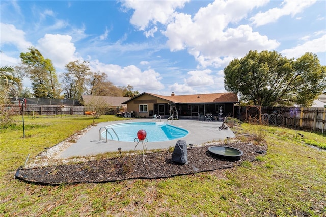 view of swimming pool featuring a fenced in pool, a lawn, a sunroom, a patio area, and a fenced backyard