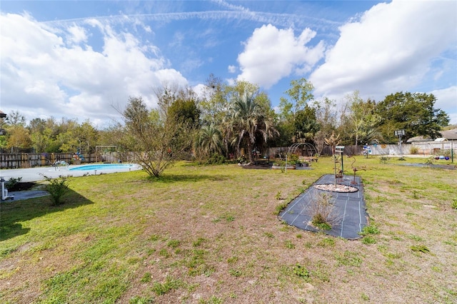 view of yard with a fenced in pool and a fenced backyard