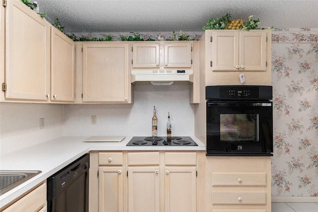 kitchen with wallpapered walls, under cabinet range hood, light countertops, a textured ceiling, and black appliances