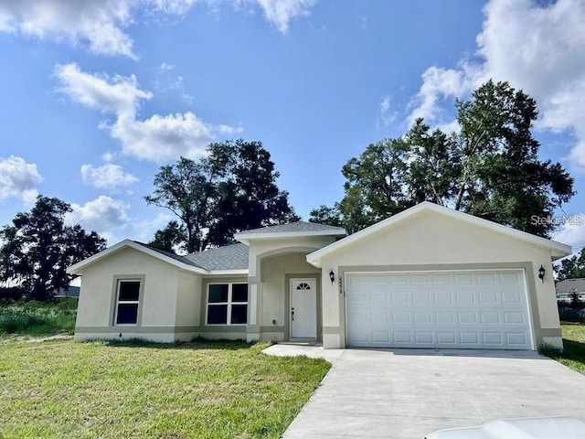 ranch-style home with a shingled roof, concrete driveway, a front yard, stucco siding, and an attached garage