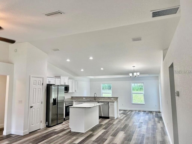 kitchen featuring white cabinets, visible vents, appliances with stainless steel finishes, and a sink