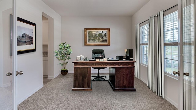 office area with baseboards, light colored carpet, and french doors