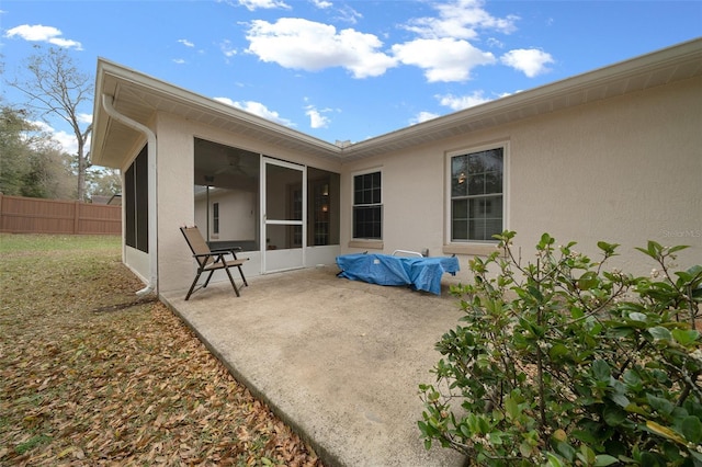 view of patio / terrace with a sunroom and fence