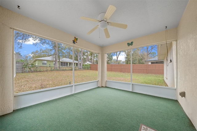 unfurnished sunroom with ceiling fan