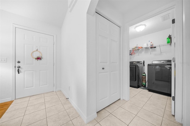 interior space featuring visible vents, independent washer and dryer, baseboards, and light tile patterned floors