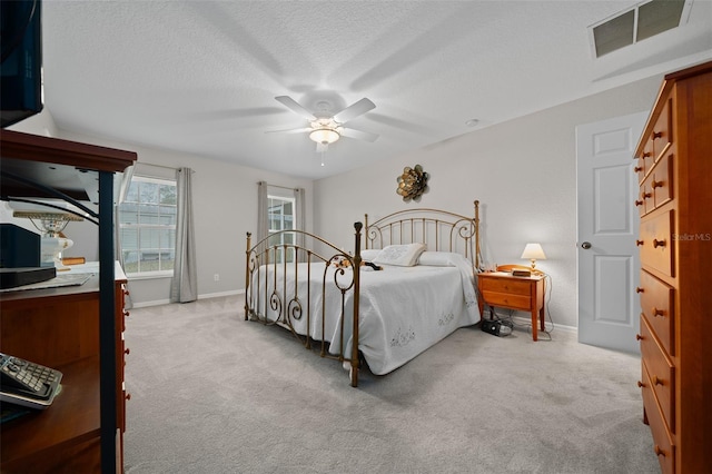 bedroom featuring a textured ceiling, carpet floors, and baseboards