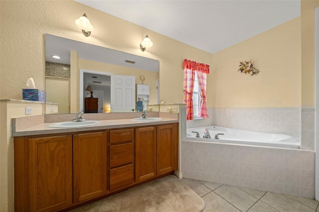 bathroom with a garden tub, double vanity, tile patterned flooring, and a sink